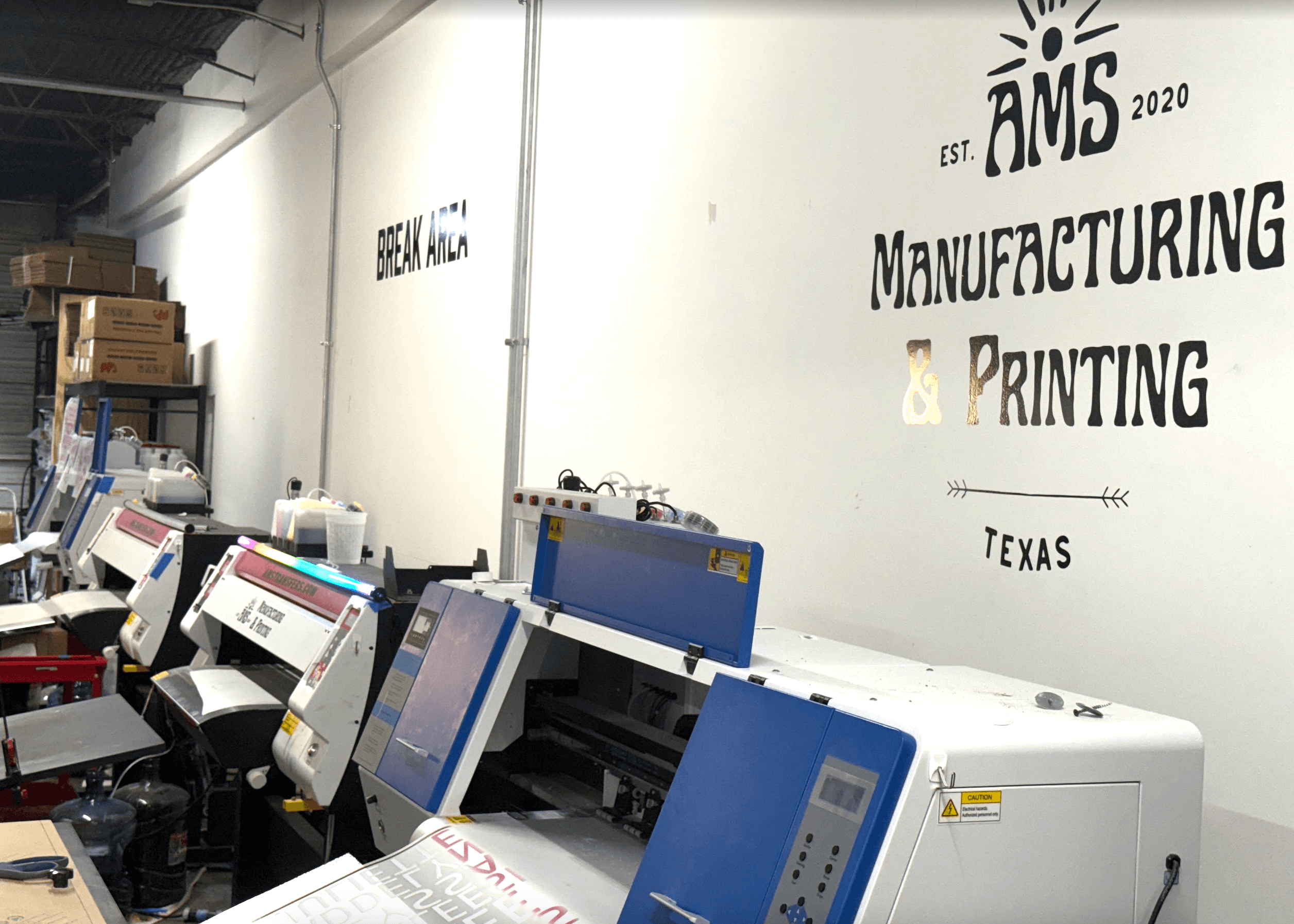 AMS Houston production floor with custom apparel orders in progress