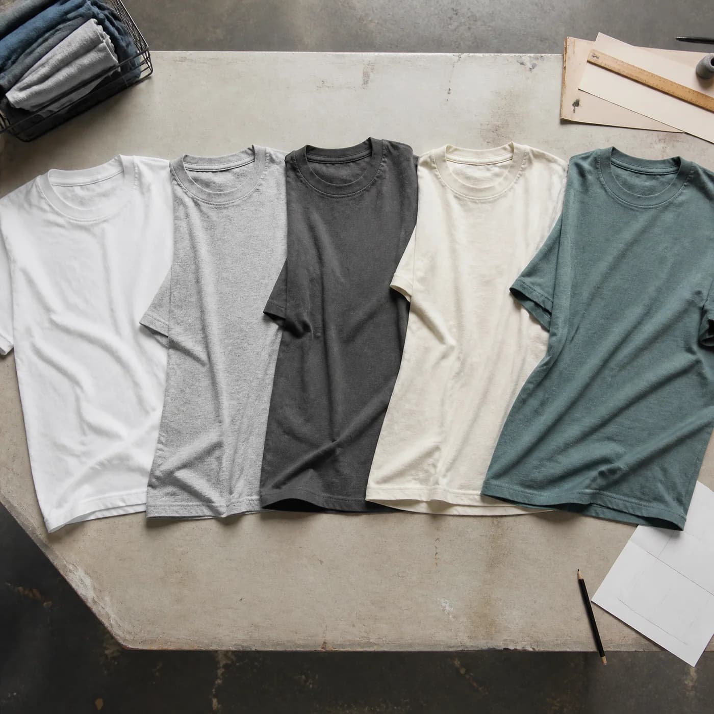 Flat lay comparison of DryBlend, Heavy Cotton, Softstyle, Bella Canvas, and Comfort Colors style shirts